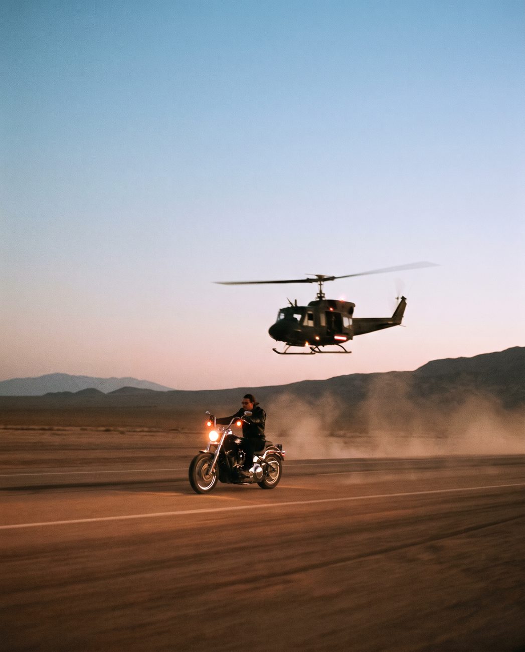 01 · Rider under the helicopter, blue hour